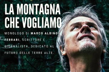 Marco Albino Ferrari scrittore e giornalista su sfondo di un bosco guarda verso l'alto